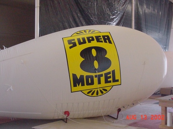 White Yellow Advertising Super Motel Blimp